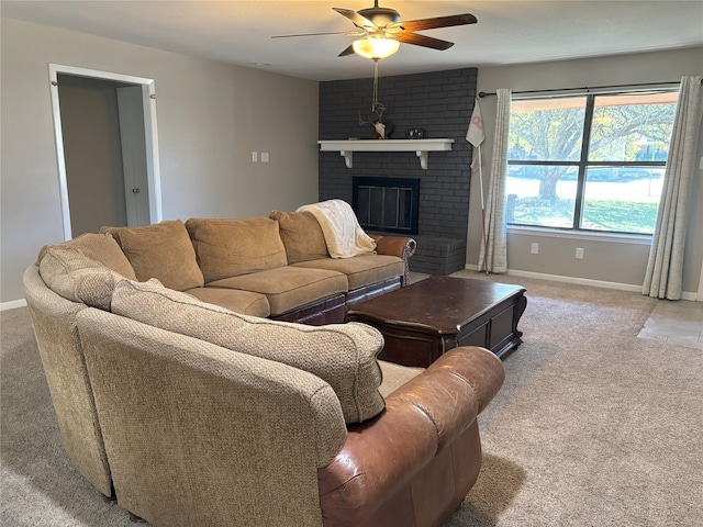 carpeted living room with ceiling fan and a fireplace