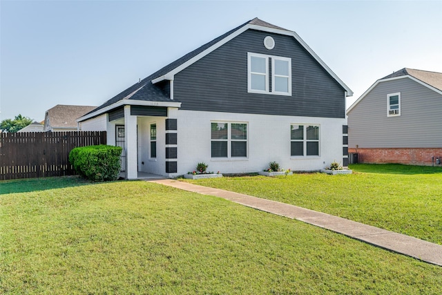 view of front of property featuring a front yard and cooling unit