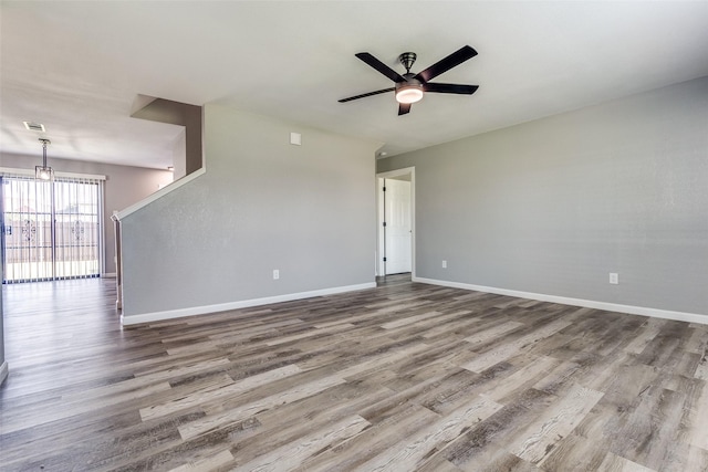 spare room with hardwood / wood-style flooring and ceiling fan