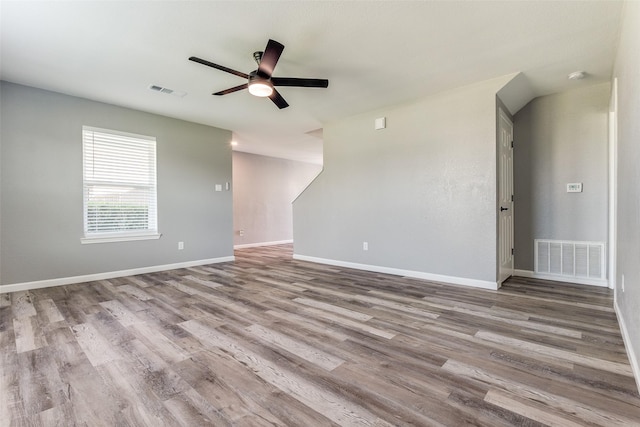 empty room featuring ceiling fan and light hardwood / wood-style flooring