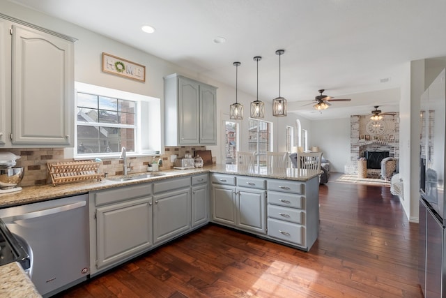 kitchen featuring sink, hanging light fixtures, stainless steel dishwasher, and gray cabinets