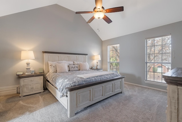 carpeted bedroom with ceiling fan and high vaulted ceiling