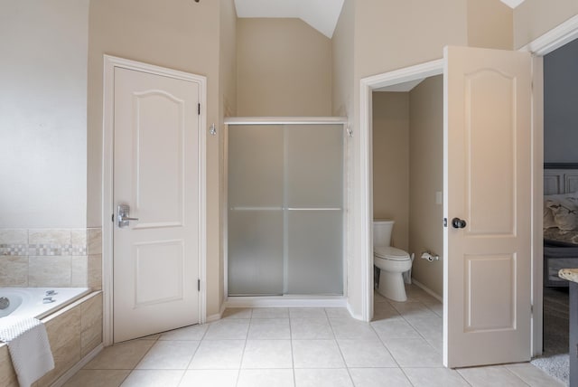 bathroom featuring toilet, lofted ceiling, tile patterned floors, and separate shower and tub