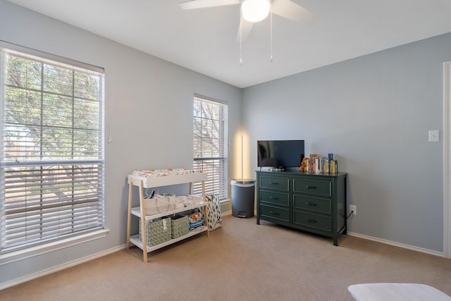 living area featuring ceiling fan and light colored carpet