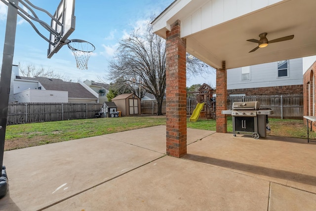 view of patio with a playground, ceiling fan, a grill, and a storage shed