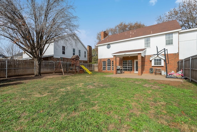 back of property with a playground, a patio area, and a lawn