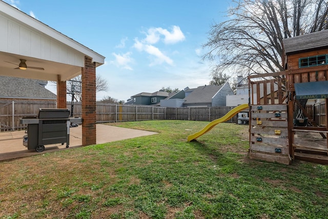 view of yard featuring a playground and a patio