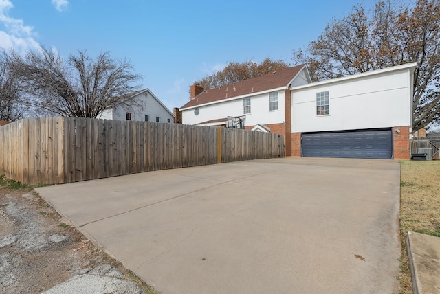 view of front of property featuring a garage and central AC