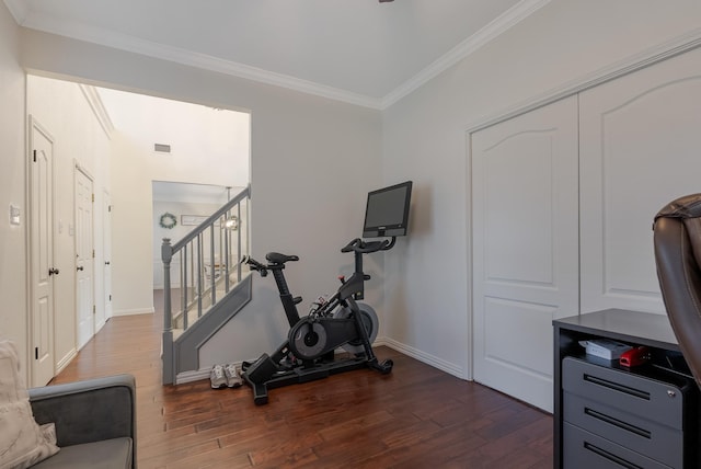 workout room featuring dark hardwood / wood-style flooring and ornamental molding