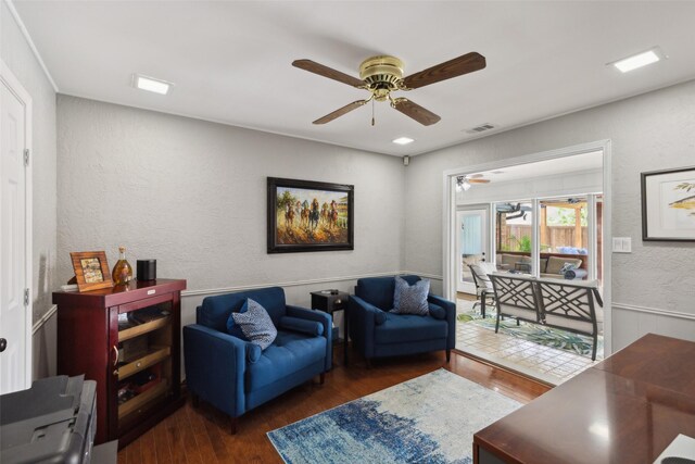 living room with ceiling fan and dark hardwood / wood-style flooring