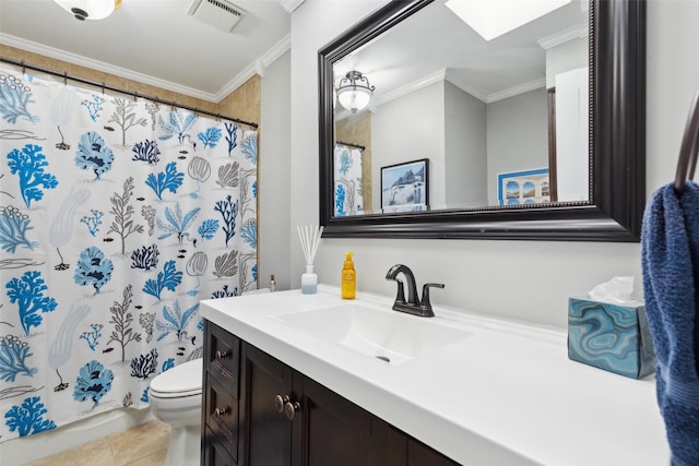 bathroom with a skylight, toilet, vanity, and crown molding