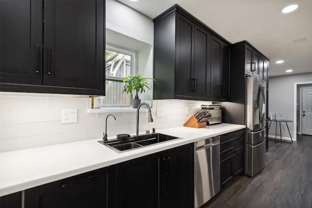 kitchen with decorative backsplash, appliances with stainless steel finishes, sink, and dark hardwood / wood-style floors