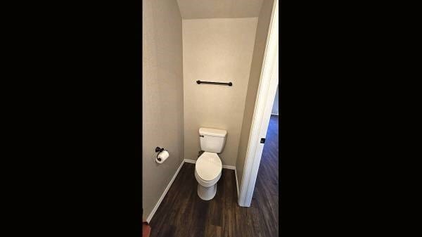 bathroom featuring toilet and hardwood / wood-style flooring