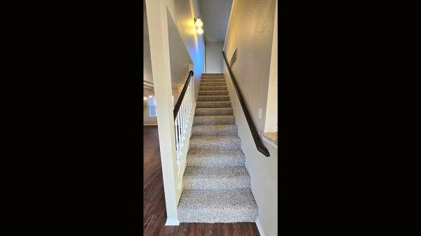 staircase featuring hardwood / wood-style floors