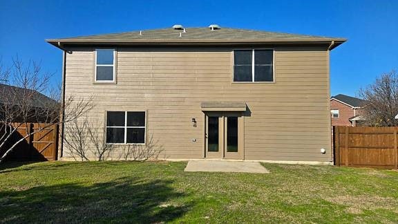 rear view of house with a patio area and a yard