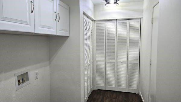 laundry room with cabinets, washer hookup, and dark wood-type flooring