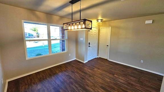 unfurnished dining area featuring dark hardwood / wood-style floors