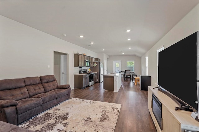 living room with vaulted ceiling and dark hardwood / wood-style flooring