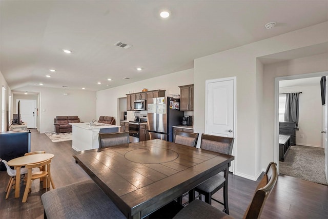 dining space with dark wood-type flooring and sink