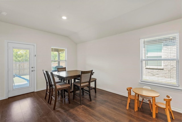 dining area with vaulted ceiling and dark hardwood / wood-style flooring