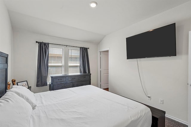 carpeted bedroom with vaulted ceiling