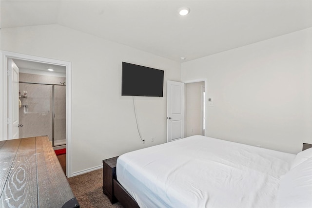 bedroom with vaulted ceiling and dark colored carpet