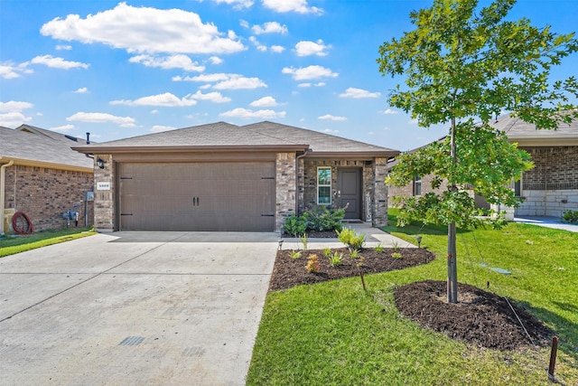 view of front of property with a front lawn and a garage