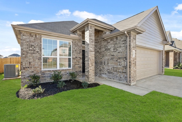 ranch-style house featuring a front lawn, a garage, and central air condition unit