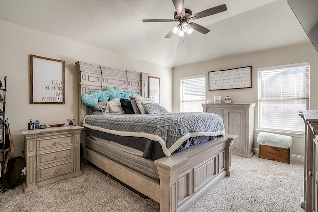 bedroom with vaulted ceiling, ceiling fan, and light carpet