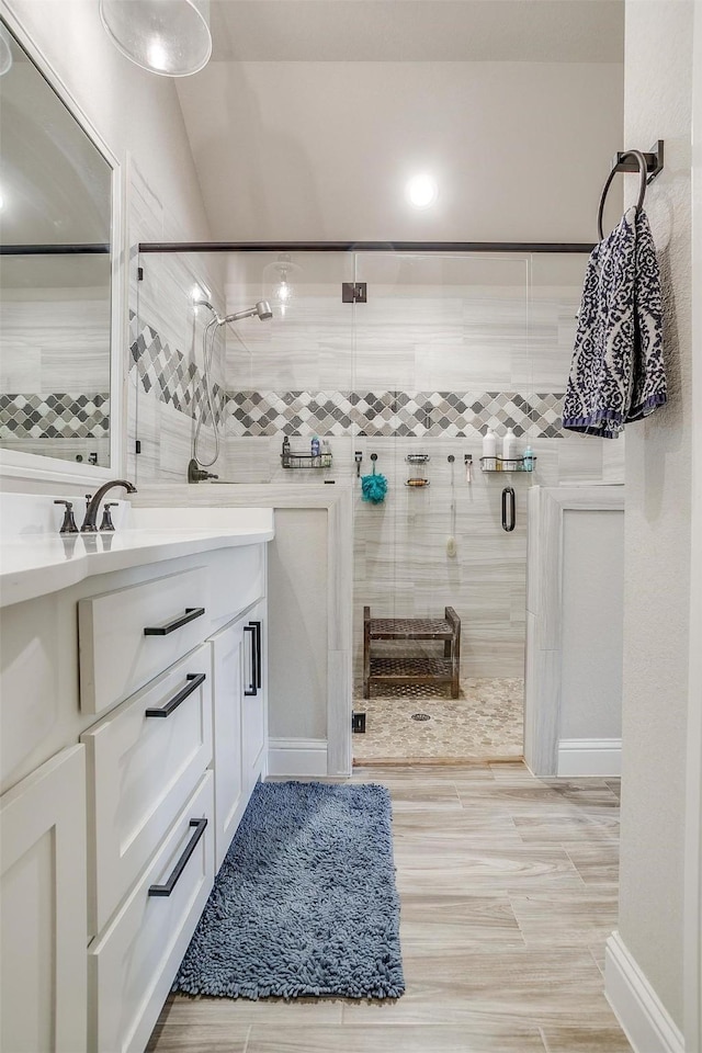 bathroom featuring vanity and an enclosed shower