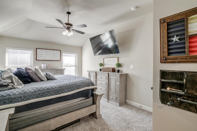 carpeted bedroom featuring vaulted ceiling, ceiling fan, and multiple windows