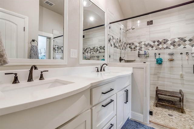 bathroom featuring an enclosed shower and vanity