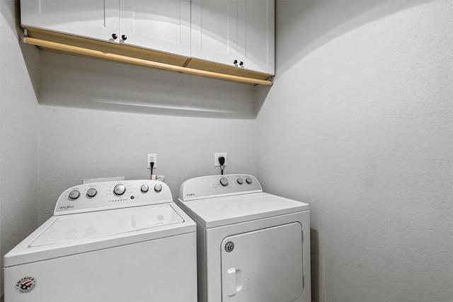 washroom with cabinets and independent washer and dryer