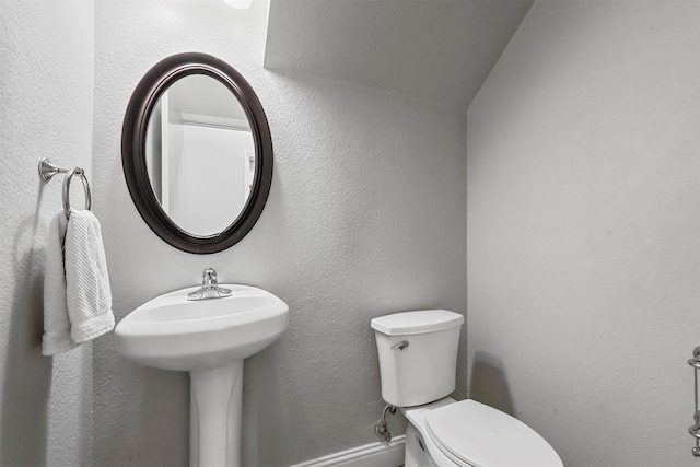 bathroom featuring toilet and lofted ceiling