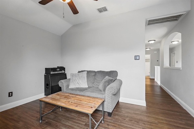 living area with ceiling fan, dark wood-type flooring, and vaulted ceiling