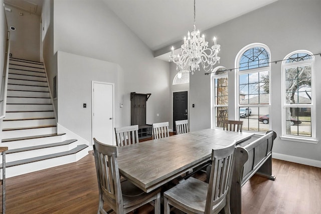 dining area featuring high vaulted ceiling and dark hardwood / wood-style floors