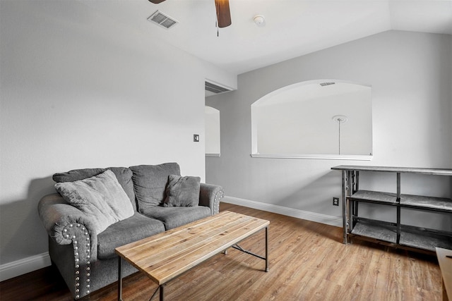 living room featuring ceiling fan, light hardwood / wood-style floors, and lofted ceiling