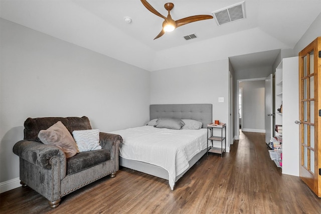 bedroom featuring ceiling fan, a raised ceiling, and dark hardwood / wood-style flooring