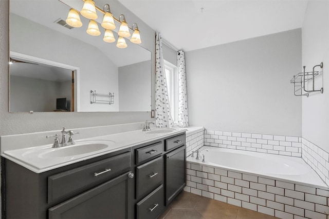 bathroom with tiled bath, tile patterned floors, vanity, and vaulted ceiling