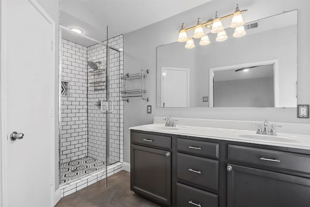 bathroom featuring tile patterned floors, walk in shower, and vanity