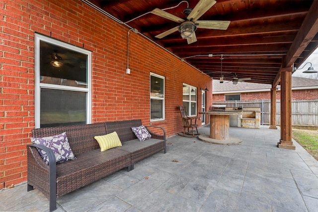 view of patio featuring ceiling fan, exterior bar, an outdoor kitchen, and an outdoor hangout area