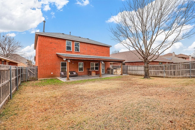 back of house featuring a patio and a yard