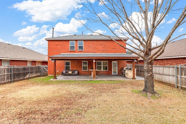 rear view of house featuring a patio area and a yard