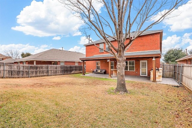 rear view of property featuring a patio area and a yard