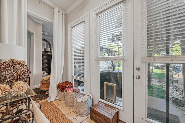 doorway with a healthy amount of sunlight, tile patterned floors, and ornamental molding