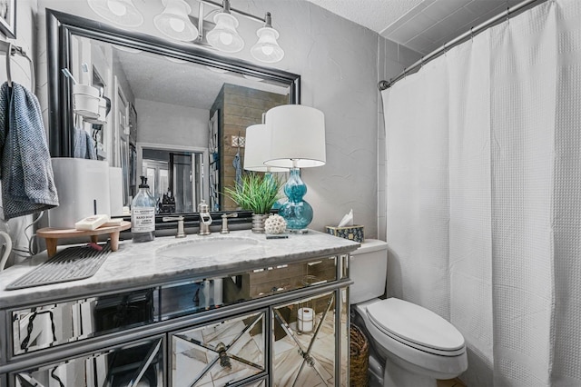 bathroom featuring vanity, toilet, curtained shower, and a textured ceiling