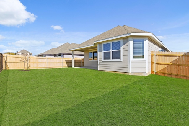 rear view of property featuring a yard