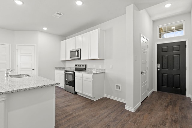 kitchen featuring light stone counters, sink, white cabinetry, and stainless steel appliances