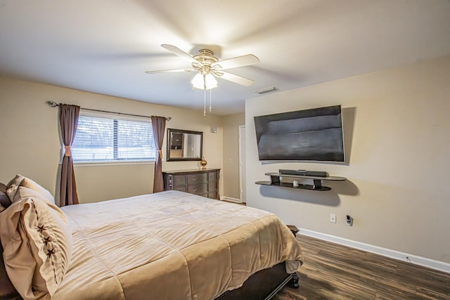 bedroom with ceiling fan and dark wood-type flooring