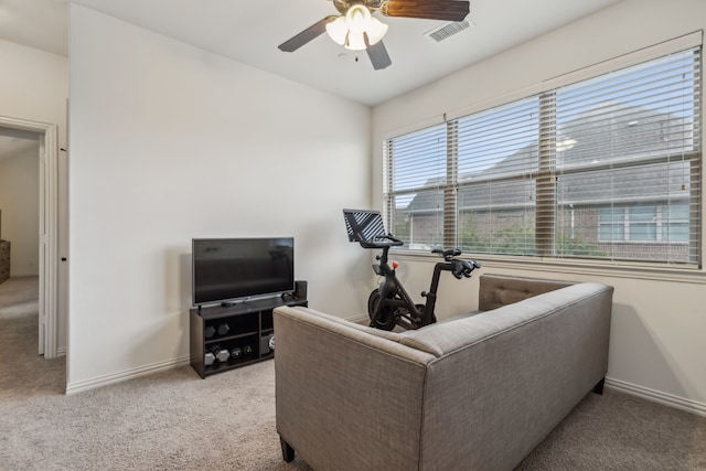 living room featuring ceiling fan and light colored carpet